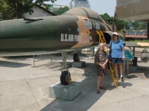 Red Cross Donut Dollies Dorset (Hoogland) Anderson and Mary (Blanchard) Bowe standing next to a Northrop F-5 Fighter Jet at the War Remnants Museum in Ho Chi Min City, Vietnam
