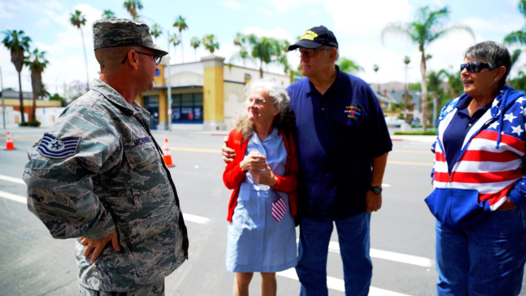 Donut Dollie Dorset Hoogland Anderson speaking with Air Force Veteran Steve Michener, Vietnam Veteran Stephen Wallace and his wife Barbara at the Salute to Veterans Parade in Riverside, CA