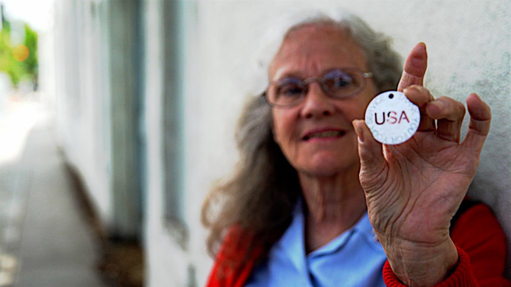 Donut Dollie Dorset Hoogland Anderson proudly showing the Thank You For Your Service medallion presented to her by Vietnam Veteran Stephen Wallace at the Salute to Veterans Parade in Riverside, CA